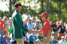  ?? ROB SCHUMACHER, USA TODAY SPORTS ?? Bubba Watson, left, with Sam Kodak, right, presented trophies for the Drive, Chip and Putt National Finals on Sunday.