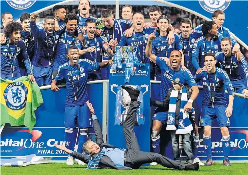  ?? EPA ?? Chelsea manager Jose Mourinho, on the ground, celebrates with his players after winning the League Cup.