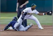  ?? JOHN HEFTI — THE ASSOCIATED PRESS ?? A’s shortstop Elvis Andrus is unable to tag out the Mariners’ Ty France during the third inning on Tuesday.