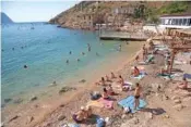  ?? AP PHOTO ?? People gather in 2015 on the beach of the Black Sea in Balaklava’s bay on the Crimean Peninsula.