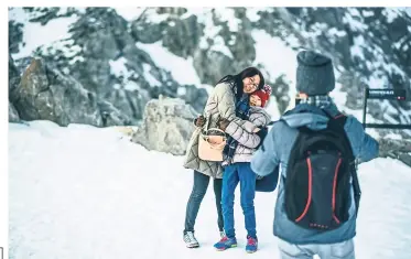  ??  ?? Have fun taking pictures with your loved ones while on a snowy getaway.