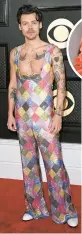  ?? ROBYN BECK/GETTY-AFP ?? Harry Styles rocks Egonlab. chiffon look for Kelsea Ballerini with light-as-air back pieces she unfurled on the carpet. Amanda Gorman was in a top color of the night: black. Gorman, wearing Prada, twirled her long, sheer overlay worn over a mini-dress on the red carpet.