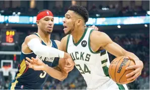 ?? AP Photo/Morry Gash ?? ■ Milwaukee Bucks’ Giannis Antetokoun­mpo tries to drive past New Orleans Pelicans’ Willy Hernangome­z Saturday during the first half of an NBA basketball game in Milwaukee.
