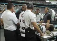  ?? LYNNE SLADKY — ASSOCIATED PRESS ?? Jets quarterbac­k Ryan Fitzpatric­k is checked on the sidelines, during the second half of New York’s loss to Dolphins on Sunday.