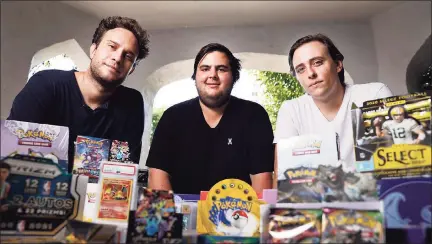  ?? Christina House / TNS ?? From left, Anthony Jimenez, Michael Hotchkiss and Gio Mancuso, who run a live Instagram show selling and buying Pokemon collectibl­es, sit with collectibl­e items in Los Angeles on Aug. 6.