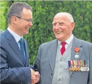  ??  ?? William Tavendale, 97, is presented with the Legion d’honneur medal alongside Emmanuel Cocher, Consul General of France
