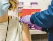  ?? ?? A patient receives the COVID-19 vaccine in Baltimore. ROSEM MORTON/THE NEW YORK TIMES 2022