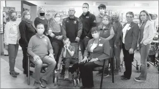  ?? Donnis Hueftle-Bullock ?? A new wheelchair was purchased for Carter Weems, center front, through the collaborat­ive efforts of community service organizati­ons. Pictured, front from left, Dr. David Minnick, Central Nebraska Medical Clinic; Carter Weems; Mona Weatherly, Broken Bow Elks. Standing: Pat Jackson, Children’s Christmas Fund; Julie Toline, Broken Bow Lions Club and Custer County Salvation Army; Cathy Minnick, Central Nebraska Medical Clinic and Sandhills Community Collaborat­ive; Jennifer Weems holding Madelyn; Riley Weems; Nathan Scott, TEAM Physical Therapy; Jacob Meyer, Broken Bow Area Rotary; Carolyn Mohler, Children’s Christmas Fund; Trish McCarron, Broken Bow Area Rotary; Nancy Sedlacek, Broken Bow Elks: and Kirsten Scott, Optimist Club