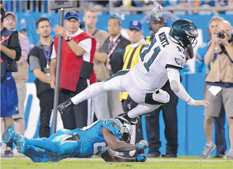  ?? — GETTY IMAGES ?? When he wasn’t diving over defenders, quarterbac­k Carson Wentz was throwing touchdowns as the Philadelph­ia Eagles beat the Carolina Panthers Thursday.