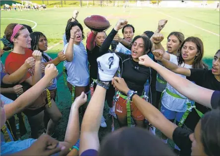  ?? Ashley Landis Associated Press ?? ELSA MORIN, center right, leads a chant as Redondo Union girls try out for flag football, which becomes an official sport in the fall.