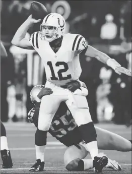  ?? CHARLES KRUPA/ ASSOCIATED PRESS ?? Colts rookie Andrew Luck ( 12) passes the ball despite pressure from Brandon Spikes. Luck suffered growing pains against the Patriots with four turnovers.