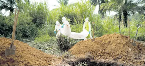  ??  ?? In this Sunday, July 14, 2019 photo, workers bury the remains of Mussa Kathembo, an Islamic scholar who had prayed over those who were sick in Beni, Congo. Kathembo himself died of Ebola. On July 17, the World Health Organizati­on declared the Ebola outbreak an internatio­nal emergency after it spread to eastern Congo’s biggest city, Goma.