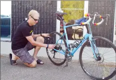  ?? NEWS PHOTO MO CRANKER ?? Hatter David Dale tune-ups his bike Friday afternoon, roughly one week before he begins his cross-Canada bike ride, as part of the National Kids Cancer Ride. He and his wife Corrie will be taking part and have raised roughly $41,000 for the cause this...