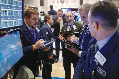  ?? (Brendan McDermid/Reuters) ?? TRADERS WORK on the floor of the New York Stock Exchange last week. A flattening of the entire US yield curve, a steep credit-market correction and the US unemployme­nt rate falling to a 50-year low are among the more eye-catching, although hardly...