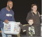  ?? STAffpHoTo­SbyCHRISTo­pHEREVAnS ?? IN A GIVING MOOD: Pats owner Robert Kraft (left) greets Marcham Robinson at last night’s Thanksgivi­ng-in-a-Basket event at Morgan Memorial Goodwill in Boston. Running back James White (right) was among the players on hand as he helps Sonia Cervera and...