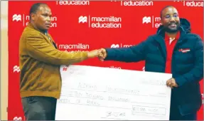  ?? ?? Alnohd Investment­s director receiving a replica cheque from the MD, Bongani Motsa. He won an amount of E10 000 in books.