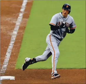  ?? JAMIE SABAU — GETTY IMAGES ?? Wilmer Flores of the Giants celebrates his two-run home run in the fourth inning against the Cincinnati Reds as he rounds first base at Great American Ball Park in Cincinnati on Monday.