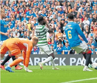  ??  ?? Celtic striker Odsonne Edouard holds his face after missing a chance at Ibrox.