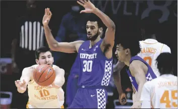  ?? ASSOCIATED PRESS ?? TENNESSEE’S JOHN FULKERSON (10) passes the ball as Kentucky’s Olivier Sarr (30) defends during a game Saturday in Knoxville, Tenn.