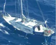  ??  ?? World voyage: Mark Brennan, pictured with a friend, and his drifting 30ft yacht