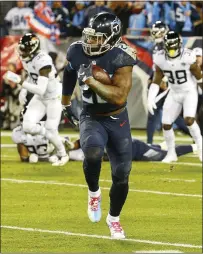  ?? FREDERICK BREEDON — GETTY IMAGES ?? Titans running back Derrick Henry sprints away from the Jaguars defense for a 99-yard touchdown during Thursday night’s win.