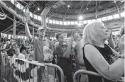  ?? [AP PHOTO] ?? Audience members react Saturday as Republican presidenti­al candidate Donald Trump speaks at Joni’s Roast and Ride in Des Moines, Iowa.