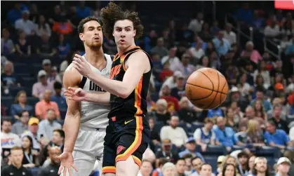  ?? Photograph: Kyle Phillips/AP ?? Dallas Mavericks center Dwight Powell, left, passes the ball around Oklahoma City Thunder guard Josh Giddey in Sunday’s game.