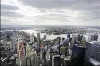  ?? MARK LENNIHAN/AP FILE ?? New York’s Financial District, foreground, the Brooklyn Bridge and East River, center, and in the distance Brooklyn are seen from the observator­y at One World Trade Center.