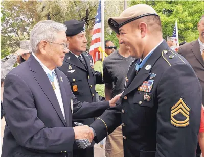  ?? PAT VASQUEZ-CUNNINGHAM/JOURNAL ?? Hiroshi Miyamura greets fellow Medal of Honor recipient Sgt. 1st Class Leroy Petry, a Santa Fe native, in front of the state Capitol in Santa Fe in July 2011 during a ceremony to honor Petry, who had recently received the medal.