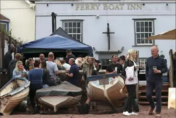  ?? Tony HIcks/Associated Press ?? People enjoy a drink Saturday outside the Ferry Boat Inn in Shaldon, England.