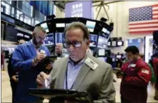  ?? RICHARD DREW — THE ASSOCIATED PRESS ?? Stock trader Salvatore Suarino works at the New York Stock Exchange, Friday.