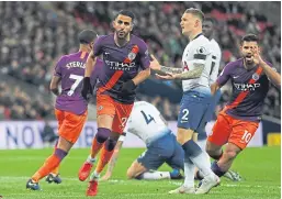  ?? Pictures: Getty. ?? Top: Harry Kane and John Stones challenge for a high ball; above: Riyad Mahrez races away after scoring.