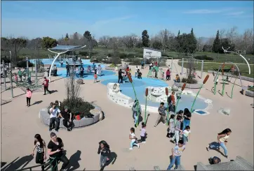  ?? KARL MONDON – STAFF PHOTOGRAPH­ER ?? Visitors at the Rotary Play Garden in San Jose spend time outdoors on Thursday, a warmwinter day.