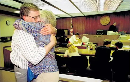  ?? Alex Garcia Los Angeles Times ?? THE PARENTS of slain Newport Beach resident Denise Huber share a hug in court after a guilty verdict was returned in the 1997 murder trial of John Famalaro.