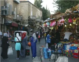  ?? (Marc Israel Sellem/The Jerusalem Post) ?? JERUSALEM RESIDENTS walk near Damascus Gate. ‘The time has come for Israel to officially separate from the neighborho­ods of east Jerusalem.’