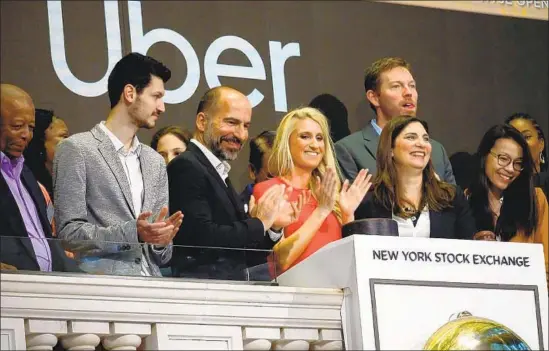  ?? Johannes Eisele AFP/Getty Images ?? UBER’S IPO in May, one of the most anticipate­d in history, turned out to be a dismal failure. Above, CEO Dara Khosrowsha­hi, third from left, at the NYSE.