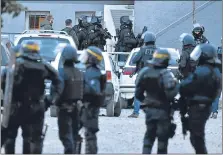  ??  ?? The siege, which took place at a supermarke­t in Trèbes, left, ended with the death of Radouane Lakdim, centre. Officers at the scene, right