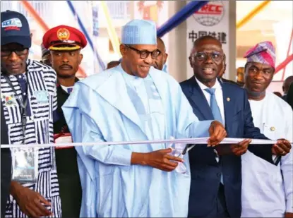  ?? TOPE AYOKU / XINHUA ?? Nigerian President Muhammadu Buhari cuts the ribbon at the inaugurati­on ceremony for the first phase of a China-built, electric-powered light rail project in Lagos on Jan 24.