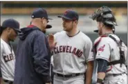  ?? JIM MONE — THE ASSOCIATED PRESS ?? Indians pitcher Trevor Bauer gives a tap to manager Terry Francona as he leaves in the seventh inning against the Twins on April 20 in Minneapoli­s. Bauer got his first win.