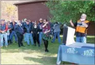  ??  ?? Brunswick Harley Owners Group director Tom Hall speaks to the crowd at the group’s 19th annual Toys for Tots Benefit Ride on Sunday in Brunswick.