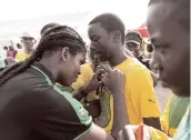  ?? PHOTOS GLADSTONE TAYLOR/PHOTOGRAPH­ER ?? Reggae Girlz forward Khadija Shaw signs the shirt of a St Jago High student athlete at the G.C. Foster College of Physical Education and Sport yesterday.