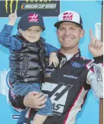  ?? AP PHOTO ?? NOT KIDDING AROUND: Clint Bowyer celebrates with his son after winning yesterday’s weather-delayed race at Martinsvil­le Speedway.