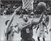  ?? ERIC CHRISTIAN SMITH — THE ASSOCIATED PRESS ?? Houston’s Eric Gordon (10), who scored 33points, drives past Utah’s Jonas Jerbko in the Rockets’ 120-99victory.