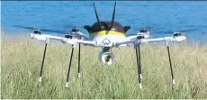  ?? RODRIQUE NGOWI/THE ASSOCIATED PRESS ?? A test drone making a UPS delivery lands on Children’s Island in Marblehead, Mass.