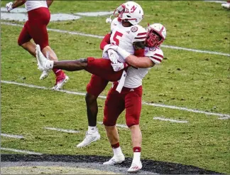  ?? MICHAEL CONROY / AP ?? Nebraska cornerback Cam Taylor-Britt (5) and linebacker Garrett Nelson (44) celebrate a fourth down stop in 2020. Taylor-Britt, the Bengals’ second-round draft pick. is expected to compete with Eli Apple to be the starting cornerback this season opposite Chidobe Awuzie.