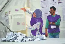  ?? MOHAMED AFRAH / AFP ?? Officials prepare to count votes for the Maldives’ parliament­ary elections at a polling station in Male on Sunday.