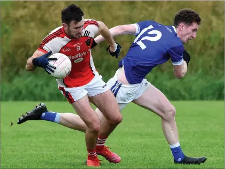  ??  ?? Brendan O’Keeffe Rathmore gets away from John Tyther Laune Rangers in the Kerry County Kerry Petroleum Intermedia­te Club Championsh­ip at Legion GAA Grounds, Direen, Killarney on Friday Photo by Michelle Cooper Galvin