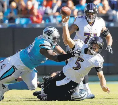  ?? STREETER LECKA/GETTY IMAGES ?? The performanc­e of Ravens quarterbac­k Joe Flacco, under pressure from Carolina’s Kawann Short, left, has dropped off after a strong start. He has completed 209 of 342 passes for 2,259 yards with 12 touchdowns and six intercepti­ons with a QB rating of 84.9.