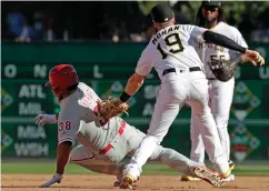  ?? Associated Press ?? ■ After driving in a run with a double off Pittsburgh Pirates relief pitcher Edgar Santana, Philadelph­ia Phillies' Jorge Alfaro (38) is tagged out by Pirates third baseman Colin Moran (19) after getting caught in a rundown between second and third...