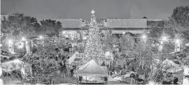  ?? Diana L. Porter / For the Chronicle ?? The Christmas tree at LaCenterra at Cinco Ranch takes center stage after the annual tree-lighting ceremony in December 2014. This year’s ceremony is Nov. 21.